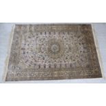 A silk rug, decorated with a central serpentine motif, bordered by flora and pedestal urns,