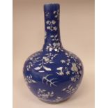 A late 19th/early 20thC Chinese porcelain bulbous bottle vase, having a long, narrow, straight neck,