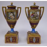 A pair of late 19thC twin handled Vienna gilded burgundy coloured and powder blue glazed porcelain