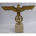 A German NSDAP desk ornament, featuring a gilded spreadeagle and wreathed swastika emblem,