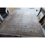 A Persian woollen carpet, decorated with stylised flora, foliage and other designs,