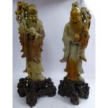 A matched pair of 20thC Chinese carved green and brown soapstone standing figures, sages,