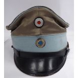 A Great War German officer's silvered peaked cap with a pale blue band (Please Note: this lot is