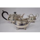 A three piece silver tea set of oval ogee form comprising a teapot with a swept spout,