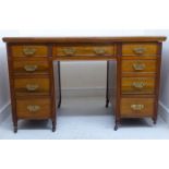 A late Victorian/Edwardian mahogany desk, having a tooled and gilded, sage green hide scriber,