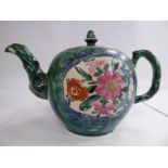 A mid 18thC Staffordshire salt glazed teapot of globular form, having a lid,