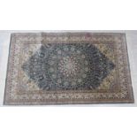 A silk rug, decorated with a central hexagonal medallion,