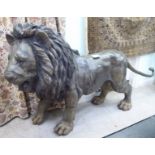 A cast bronze standing model lion approx.