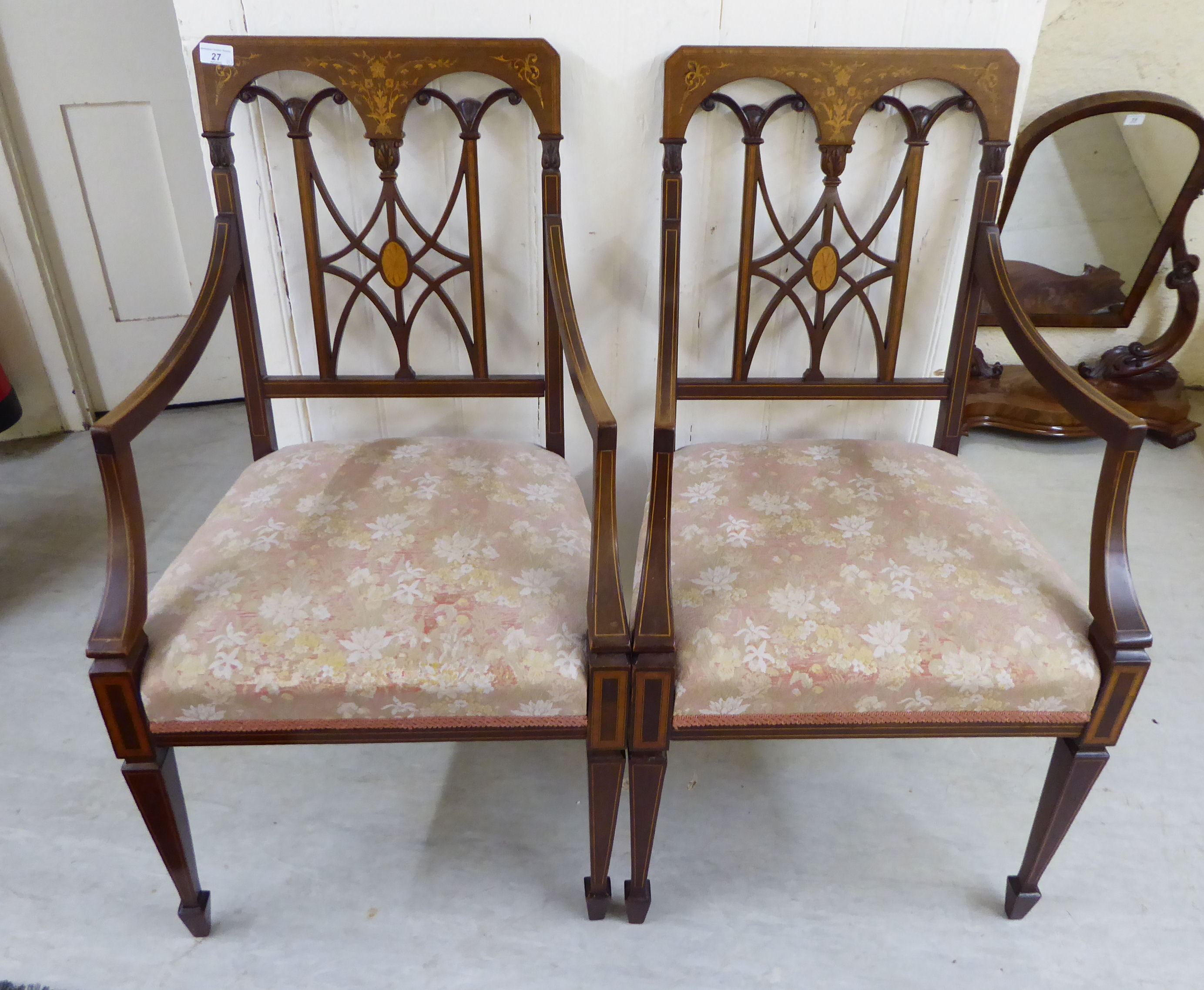 A pair of Edwardian string and marquetry inlaid mahogany framed open arm chairs,
