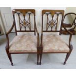 A pair of Edwardian string and marquetry inlaid mahogany framed open arm chairs,