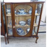 An Edwardian mahogany breakfront fully glazed display cabinet with floral painted ornament,