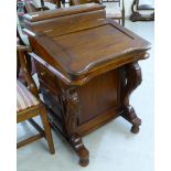 A modern reproduction of a Victorian mahogany Davenport with a hinged top,