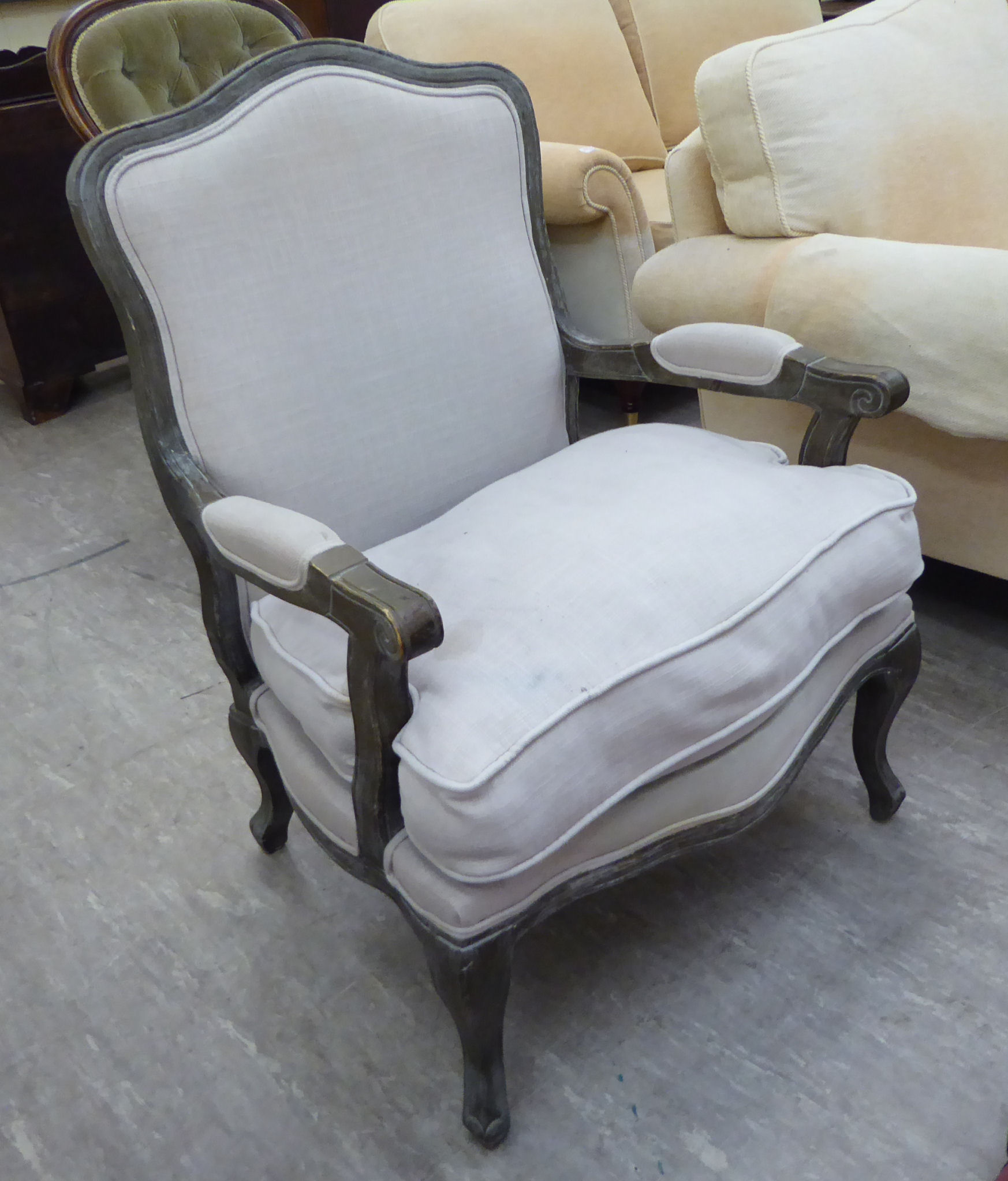 A modern French inspired washed oak showwood framed open arm salon chair,