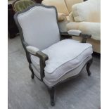 A modern French inspired washed oak showwood framed open arm salon chair,