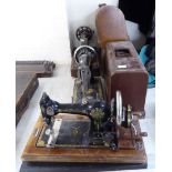 Two similar manual Singer sewing machines, model no.