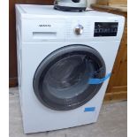 An (unused) Siemens IQ500 Wash & Dry, in white casing 33''h 23.