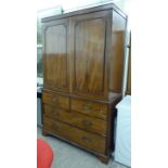 A George III mahogany linen press with a pair of panelled doors,