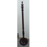 A 1920s mahogany standard lamp with a knopped and reed carved stem,