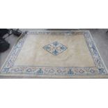 A Chinese cotton carpet, decorated with stylised floral and other designs,