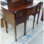 An early 20thC string inlaid and crossbanded mahogany, serpentine front sideboard,
