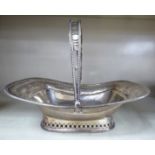 An early 20thC silver bread basket with a swing handle and pierced shallow basket Sheffield 1926