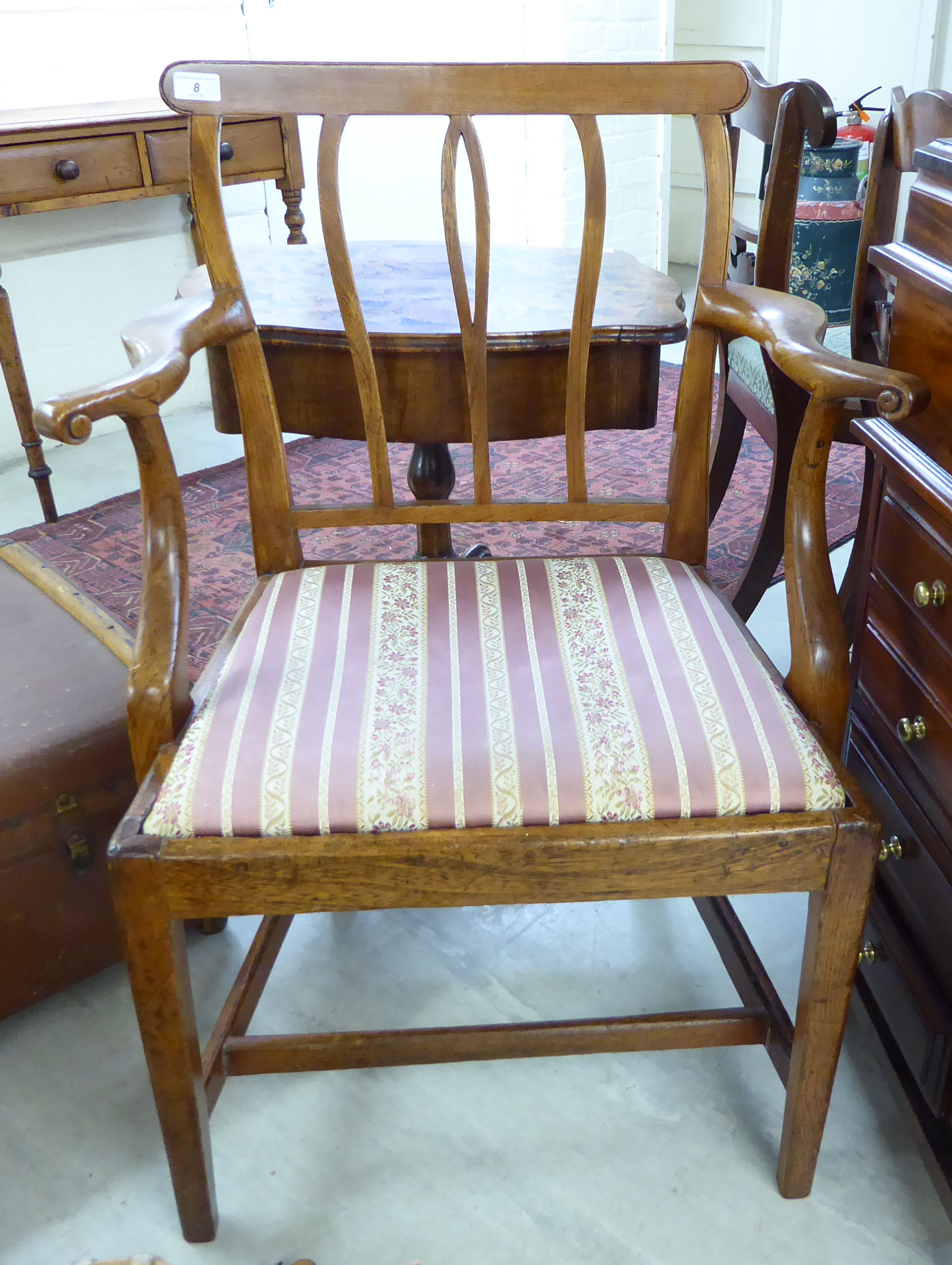 A mid/late 19thC beech and elm framed country made elbow chair, the later covered,
