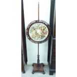 A William IV mahogany polescreen, set with a peacock and floral embroidered panel,