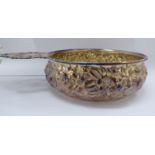 A Sterling silver quaiche inspired bowl with floral embossed ornament,