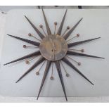 A 1950s US made iron Sunburst Atomic wall clock 25''dia SR