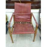 A mid 20thC stained wooden framed salon 'Safari' chair with a maroon coloured hide back,