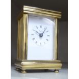 A modern Asprey lacquered brass cased miniature carriage style timepiece with a bevelled glass