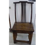 A Chinese elm framed official's hat chair with a solid seat and block, cut-out front,