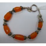 A silver coloured metal and agate set bracelet,