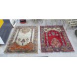Two similar Persian design machine made woollen rugs, decorated with flora and stylised designs,