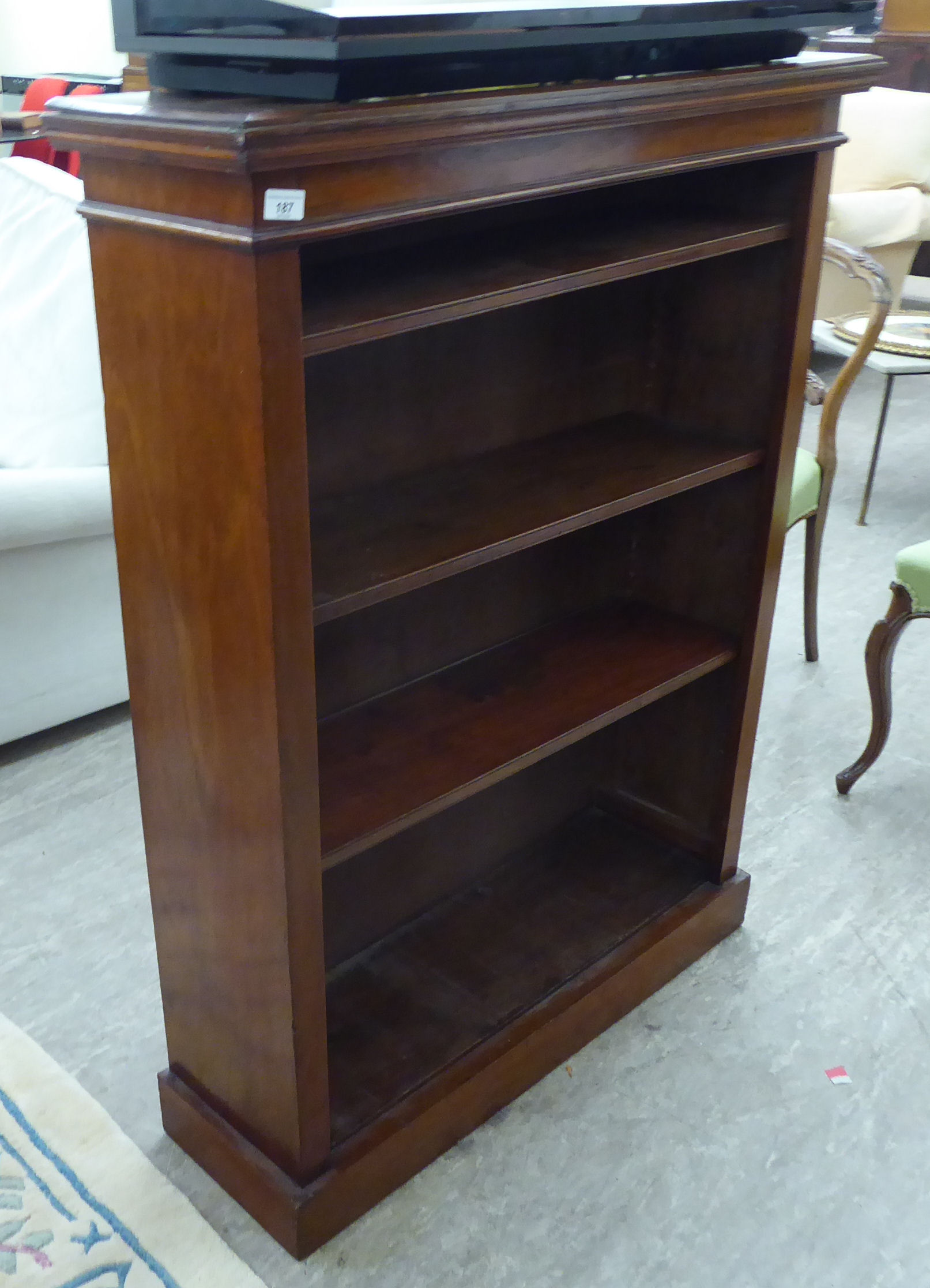 A late Victorian mahogany open front bookcase with three height adjustable shelves,