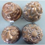 Four Victorian style copper jelly moulds of domed form,