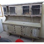 A modern washed oak dresser, the superstructure with four glazed doors,