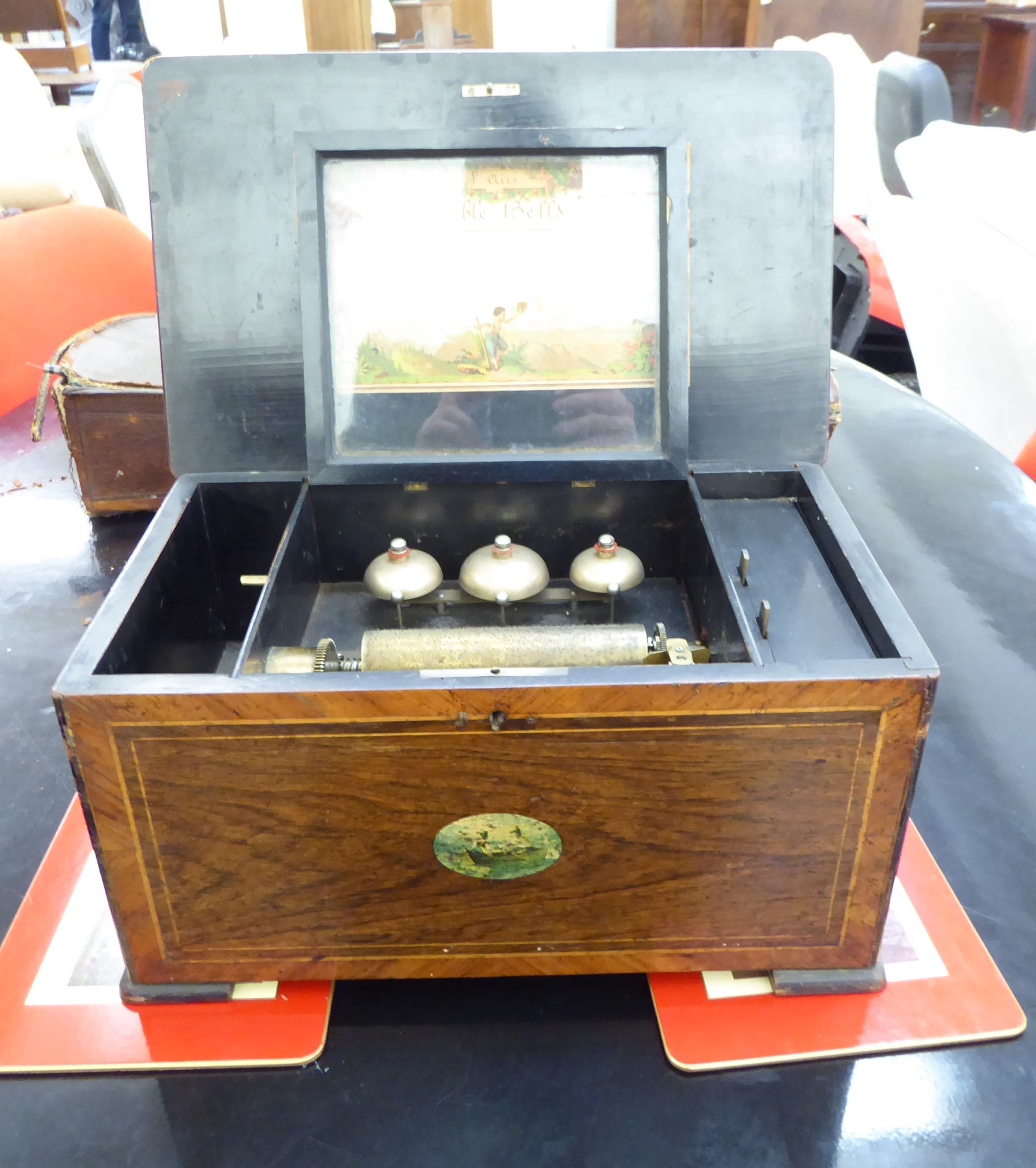 A late Victorian crossbanded walnut and rosewood finished music box with straight sides and a