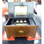 A late Victorian crossbanded walnut and rosewood finished music box with straight sides and a