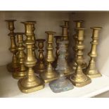 Thirteen similar 19thC brass candlesticks 7''-11''h OS6