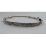 A 9ct white gold and diamond set bangle 11