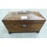 A Regency rosewood tea casket of sarcophagus form, enclosing two lidded caddies 6.