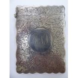 A late Victorian silver card case of serpentine outline with a hinged cap and bright-cut foliate