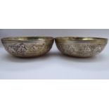 A pair of Asian white metal bowls with decoratively cast borders 2.