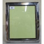 A silver cushion moulded glazed photograph frame,