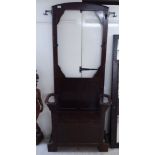 A 1930s oak hallstand incorporating a hinged seat,