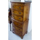 A modern burr walnut and mahogany six drawer tallboy,