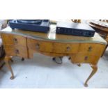 A mid 20thC walnut five drawer kneehole dressing table,