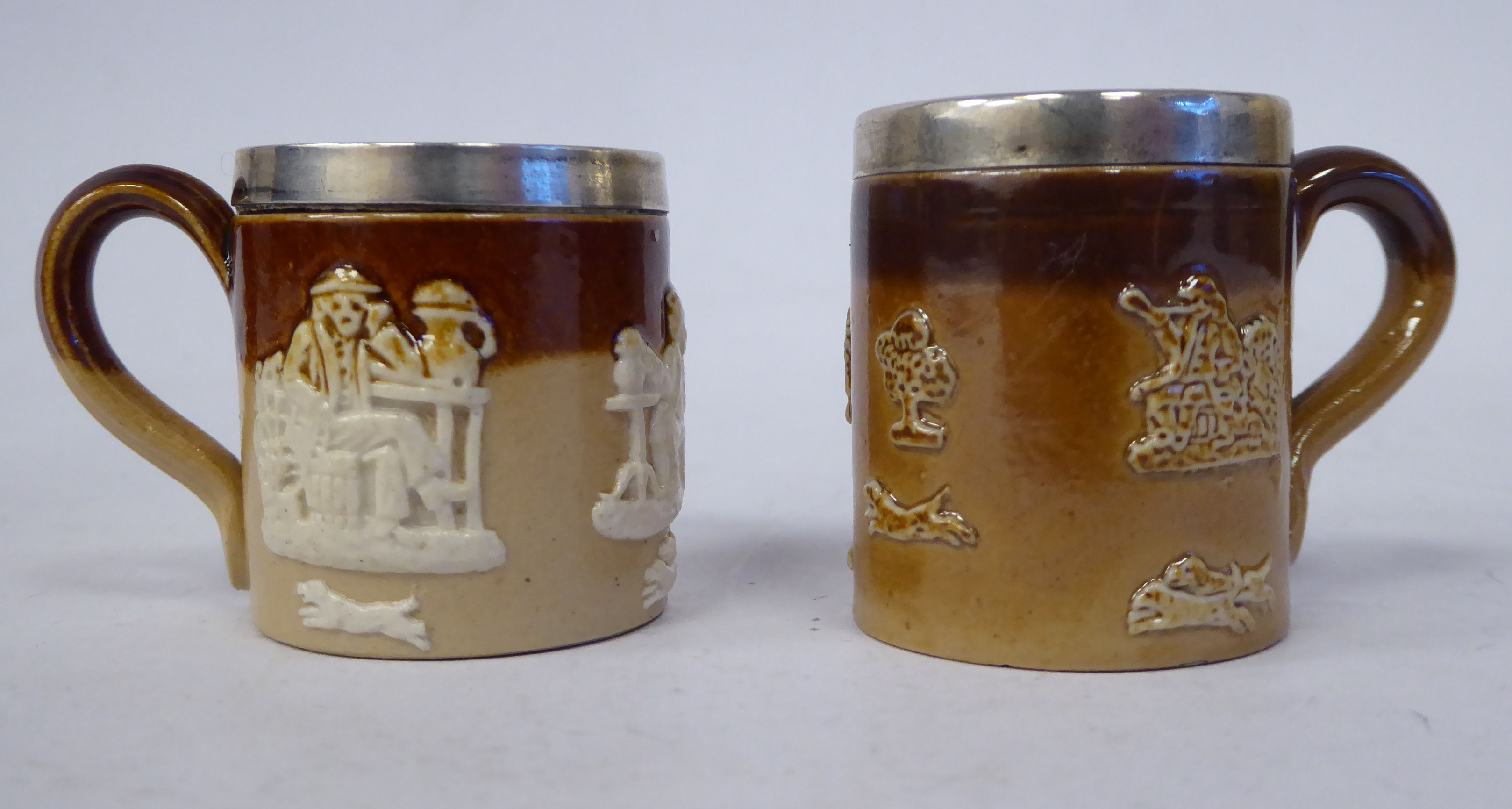 Two similar early 20thC Doulton Lambeth two tone brown glazed stoneware,