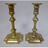 A pair of loaded silver candlesticks, each having a detachable sconce in the vase shaped socket,